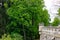 Wall of Hluboka Castle with green trees of Zamecky park during spring, in Hluboka nad Vltavou Czech Republic
