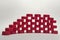 Wall with holes pattern. made of the red ribbed plastic bottle