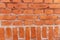 Wall of horizontal and vertical orange bricks