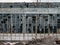 Wall with large broken windows in abandoned ruined factory building, broken glass and destructed old plant facade