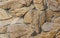 Wall from large stones background texture, stone slate wall concrete grout, rock