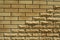 Wall of light smooth and uneven bricks