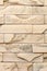 Wall made of decorative beige stone. Background