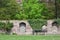 A wall made of stone blocks with a climbing plant on the territory of an old castle in Germany. Antique wall and bench