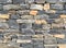 Wall masonry finishing from colorful natural stone trim as background front view closeup