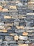 Wall masonry finishing from colorful natural stone trim as background front view closeup