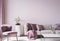 Wall mock up for modern sofa on light pink wall background with trendy home accessories