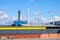 Wall of modern factory building and roof with exhaust and ventilation chimneys