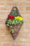 Wall mounted hanging basket with spring flowers