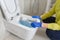 Wall mounted toilet cleaning. hotel maid cleans toilet with a scrub brush. woman household service