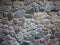 Wall of multicolored cobblestones in a contrasting dramatic style