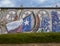 Wall mural on a Dallas recycling business decorated with the Texas flag and state flower.