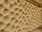 The wall of an old block-shaped house is newly repaired and has the color of the ocher depression looking porous bone structure