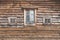 Wall of an old farm building. Natural wooden texture, rural house for agritourism, different windows, country house