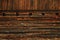 The wall of an old rustic wooden cottage inhabited by the shepherds during the summer in the Carpathians, Fundatura Ponorului