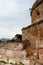 The wall of the old tower. The brick collapsed the fence. Antalya, Turkey, April 6, 2019