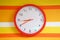 Wall orange clock on colorful