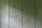 Wall with pale green color and holes punched or shot