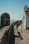 Wall with pathway and watchtower in front of old house