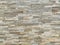 Wall. Photograph of an exterior brick wall in various shades of brown. Wall texture.