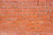 Wall of red brick with fluted texture