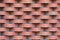 A wall of red brick laid in horizontal rows.