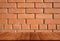 Wall of red bricks. Background. View from dark wooden gangway, t