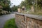 Wall with rocks, grass, plants and leaves in the road