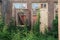 The wall in the room of an abandoned wrecked house with empty windows