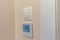 On the wall of the room there is a light switch and under it a floor heating switch with a temperature controller