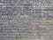 A wall with a rough textured masonry covered with divorces and darkened. Not seamless texture
