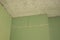 The wall is sheathed with moisture-resistant green plasterboard in the apartment, renovation work