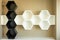 Wall shelves in the form of hexagons in white and black. Bee honeycombs