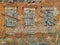 Wall and shutters of crumbling adobe house