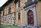 Wall, with solid wood door on the left and on the right, many coats of arms on the ground floor of the beautiful villa Montughi or