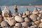 The wall of stones collected in a pyramid on the beach pebbles are not large