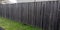 Wall street wooden brut fence barrier around private house protect raw view home garden