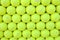 Wall of tennis balls aligned - background