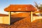 Wall and tiled gate buried in sand dunes in the desert in Al Madam ghost village, United Arab Emirates, sunset