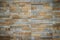 Wall tiles patterned like natural split stone background. Simulated yellow natural stone facade, wall tiles texture.