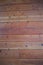 Wall of Vertical  Knotty Pine In Reddish Hue