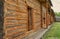 A wall of a village barn made of logs, a courtyard of a 19th century estate