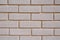 Wall of white bricks with yellow fugue