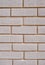 Wall of white bricks with yellow fugue