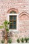 Wall with a window and a palm tree, Dzhumaya Mosque, Plovdiv, Bu