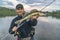 Walleye fishing. Happy fisherman with zander fish at river