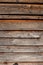 Wallpaper in the form of a wooden wall on the house. The wall is made next to the piles of pine wood. Copy Space. Wooden. Sun