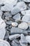 Wallpaper of various gray and orange rocks of different sizes and shapes on the sea coast