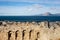 The walls of the medieval Patras Castle in Greece at sunrise with the city and sea