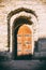 Walls of old fortress. Wooden door, entrance